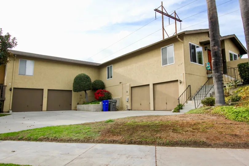 Two light brown garage doors across from two dark brown garage doors in Lake Village at Oceanside CA