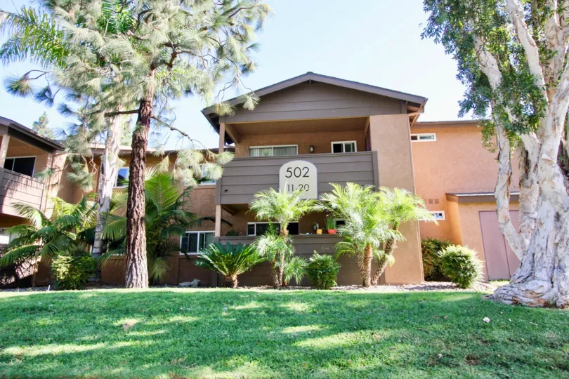 a beautiful mansion in Lakeshore Villas community with a cute lawn in the sunshine