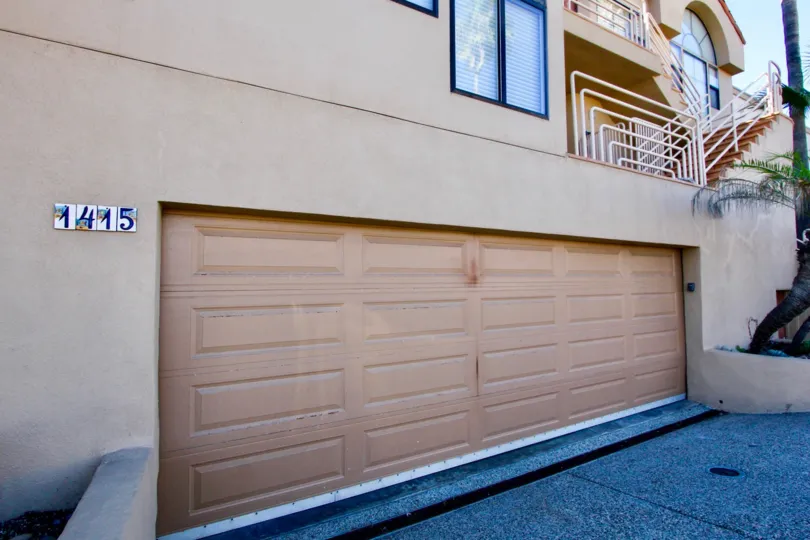 A sunny day in the area of Las Olas, outside, garage, stairs, tree, driveway