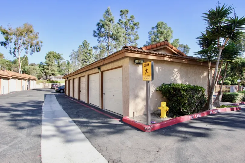 A cross road and a side view of a house with SLOW sign board at Loma Alta Village