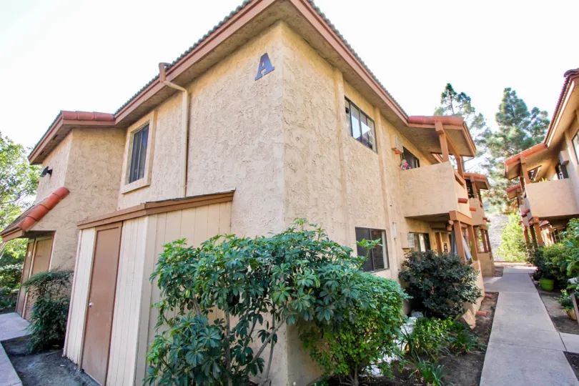A walkway goes to the doors of multiple condos at Loma Alta Vista
