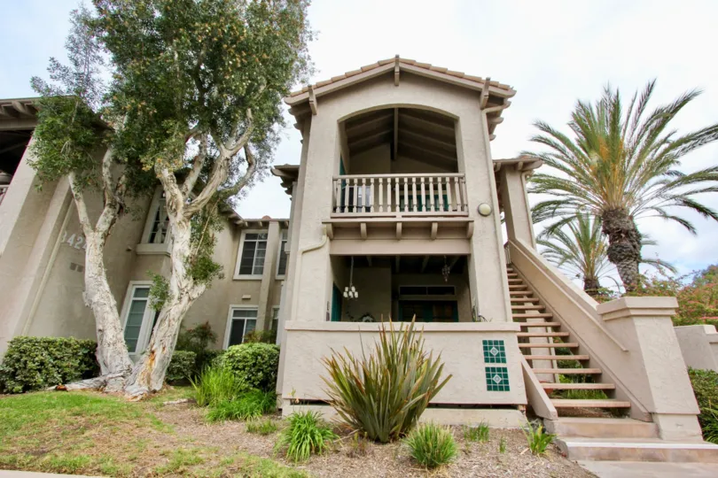 Condo with stairs and balcony and bashes in warm area