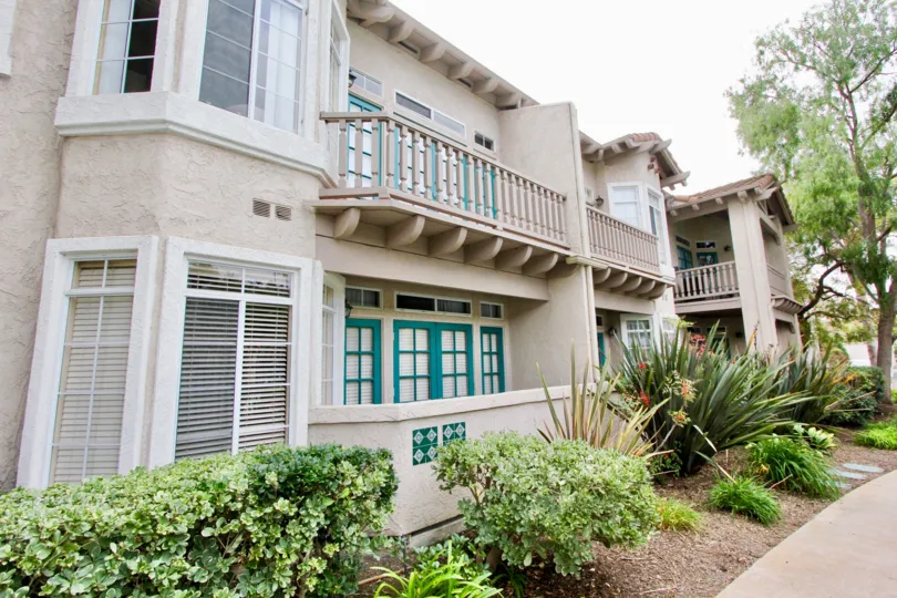 Two story light brown building with brown railing in Oceanside CA at Lomas De Oro