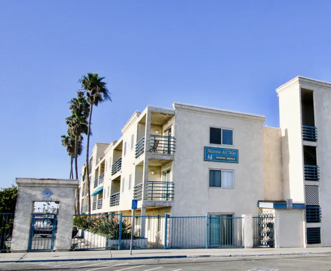 Street view of the building with blue color compound gate in Marina Del Mar