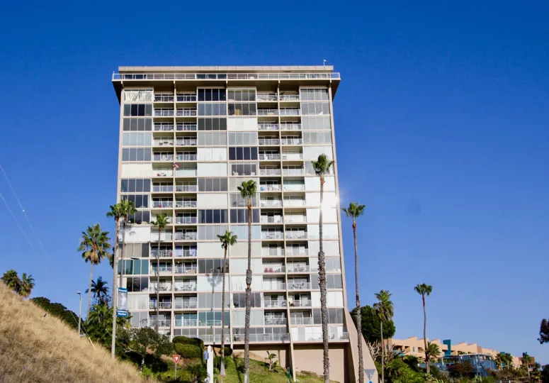 A tower amid some trees at Marina Towers in Oceanside CA