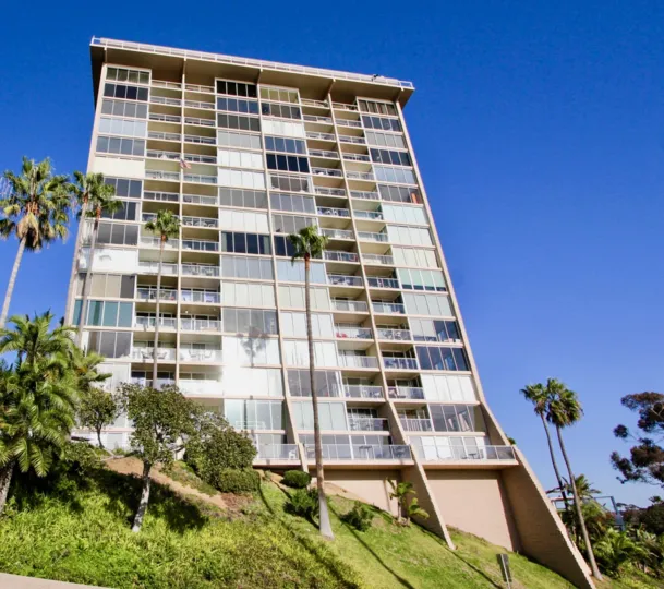 Unobstructed views, with tall mature palm trees and ample windows for natural light at Marina Towers in Oceanside, CA