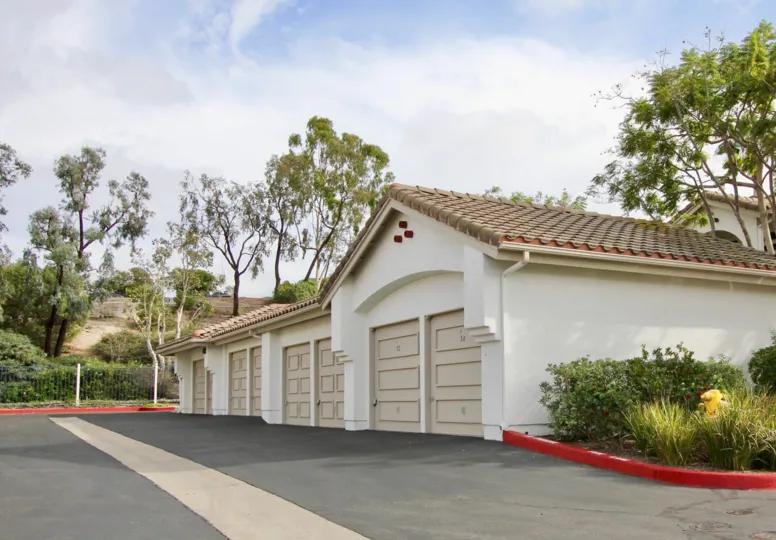 Garages in front of some trees in Mission del Oro in Oceanside, CA