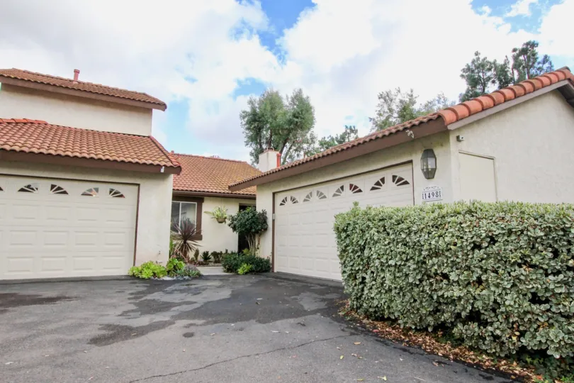 Two house garage and big space outside with plants in Mission Meadows
