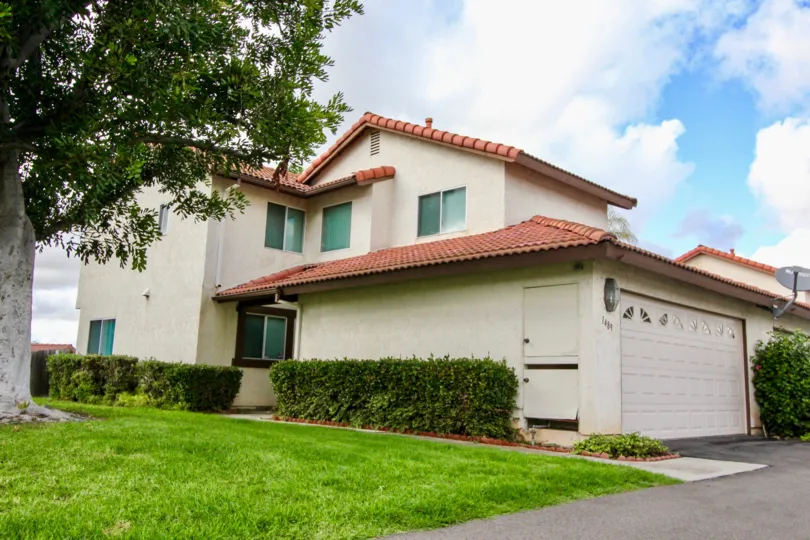 A pleasant day in Mission Meadows neighborhood with house garage and green grasses