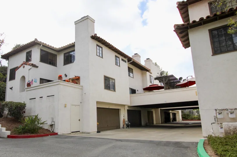 Curve shaped roof residences with car parking area at the down in Mission Point Townhomes.