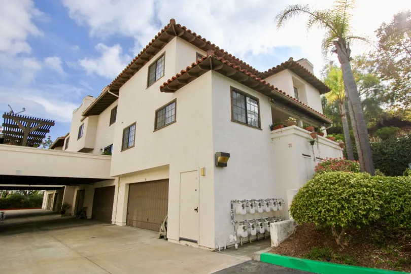Three story brown housing with gas meters on the side at Mission Point Townhomes in Oceanside CA