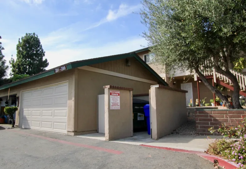 Detached double car garage with access to communal garbage receptacle at Mission Vista in Oceanside, CA