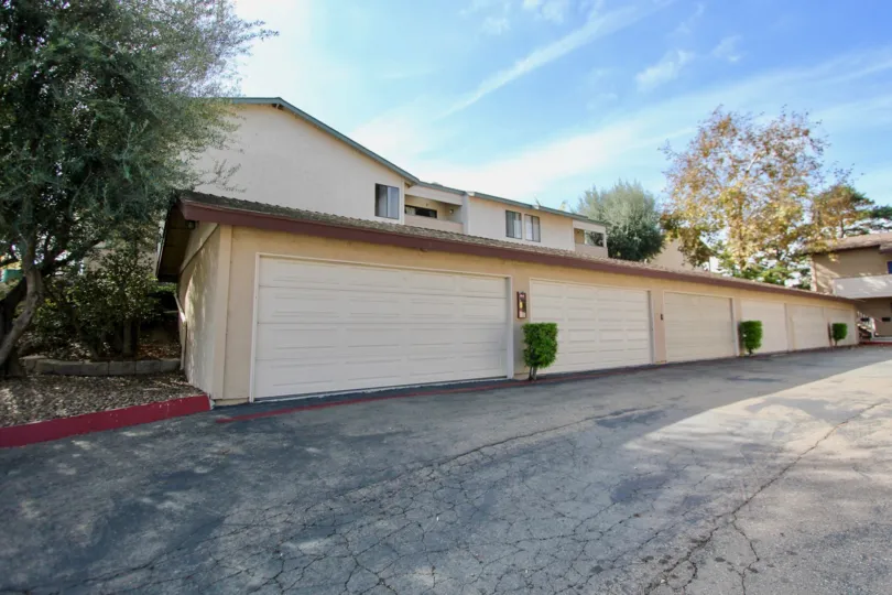 Garages with bushes at Mission Vista in Oceanside, CA