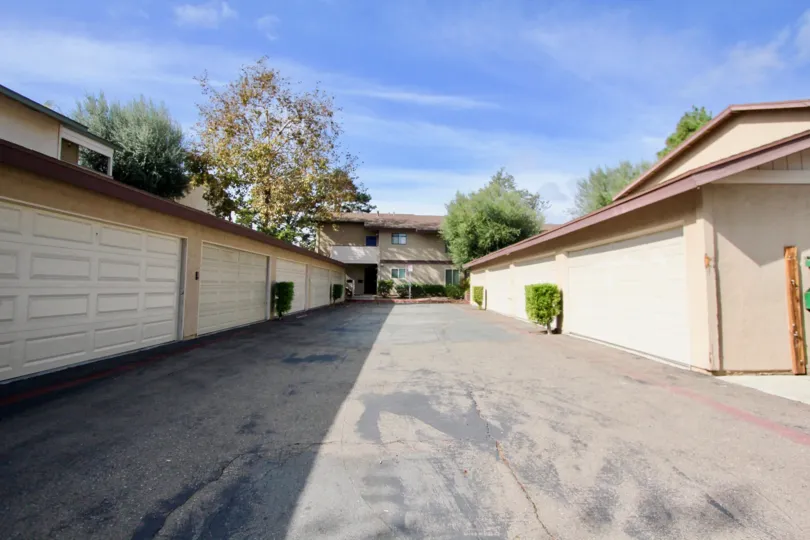 A wide road leading to an independent house and side view of two other houses at Mission Vista