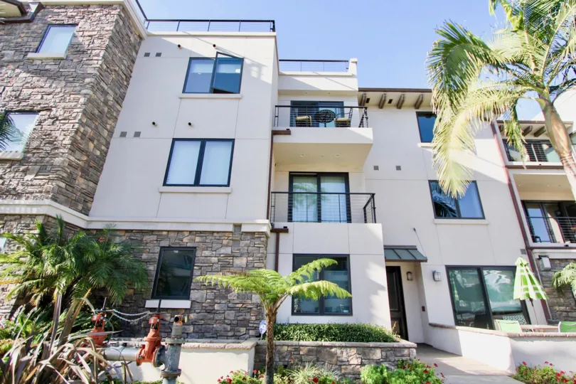 Three stair building with overview balcony and textured walls in Montego Condominiums.
