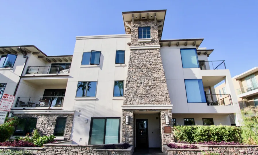Two-story building with a brick element in Montego Condominiums