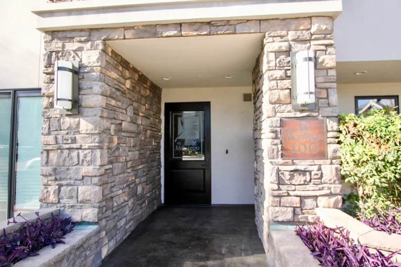 A bronze placard sits on a stone pillar at Montego condos