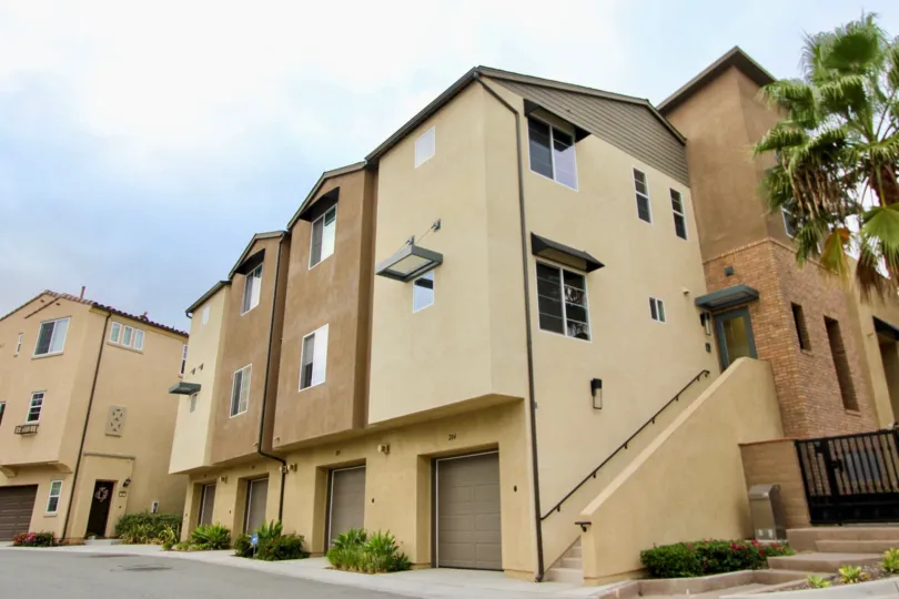 Entry staircase and brown garage doors at North River Village in Oceanside, California