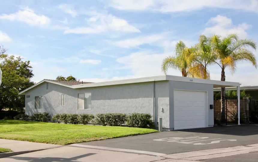 Single story long gray home with yard & attached garage inside Oceana south in Oceanside CA