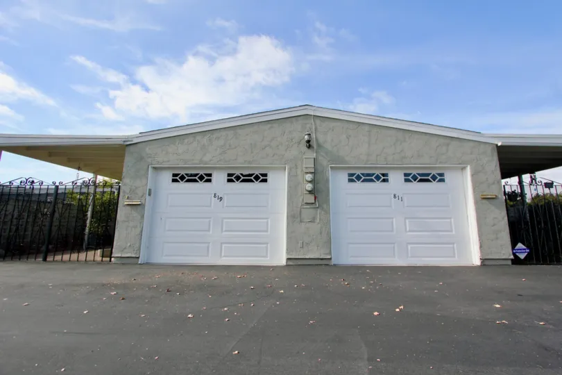 Two white garage doors with windows at Oceana South in Oceanside California