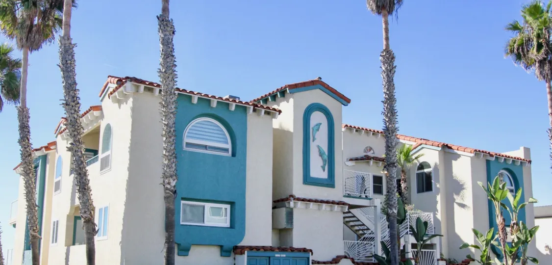 A sunny day in the area of Oceanfront Paradise, Outside, palm trees, condos, stairs, balcony, flowers