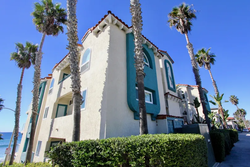 Beautiful white homes with blue trim at Oceanfront Paradise.