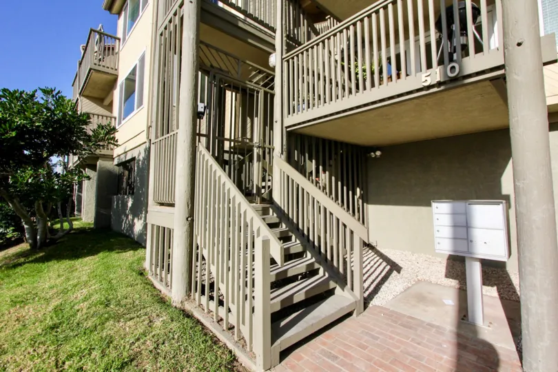 A lawn by some stairs leading to a unit in Pacific Star Pine in Oceanside, CA