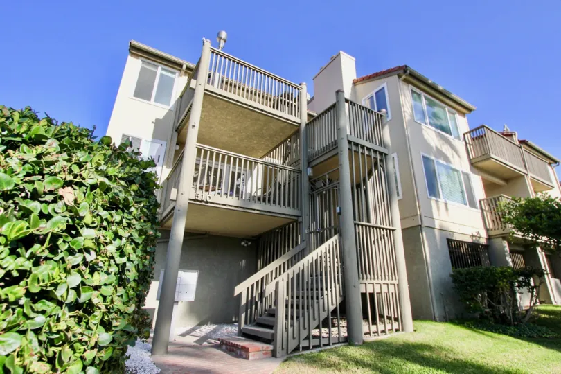Two balconies sit one under the other on a building at Pacific Star Pines condos