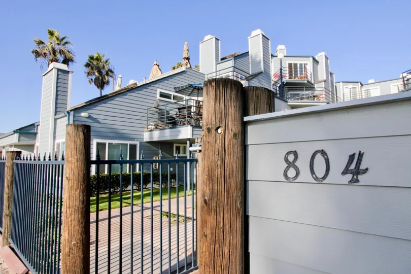 Black address numbers on a gray wall at Pacifica Strand in Oceanside California
