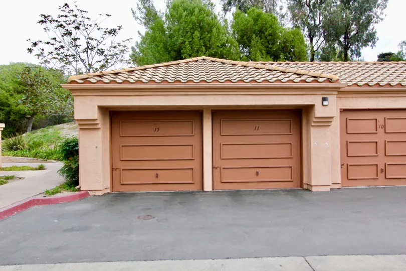 A sunny day in the area of Palmilla Del Oro, outside, trees, sidewalk, garages, light