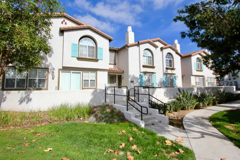 A sunny day in the area of Pelican Cove, outside, stairs, condos, sidewalk, trees