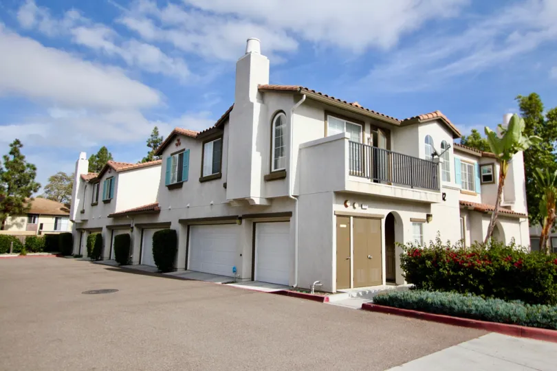 A beautiful two story condo with a balcony view with a attached car garage