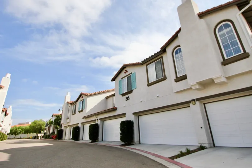 A sunny day with houses and a desert street in Pelican Cove
