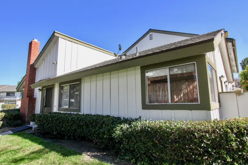In the Pepperwood Villas area in Pceanside, CA an older model home is on the corner.