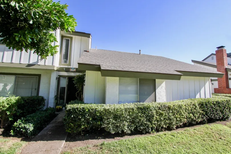 Two story housing with hedges inside the Pepperwood Villas community at Oceanside Ca