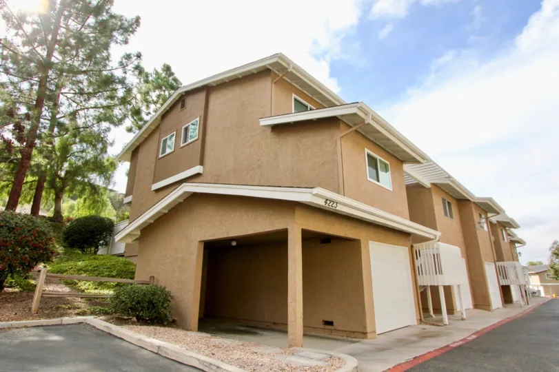 A sunny day in the area of Quail Ridge, garage, covered entrance, trees, outside, wooden fence