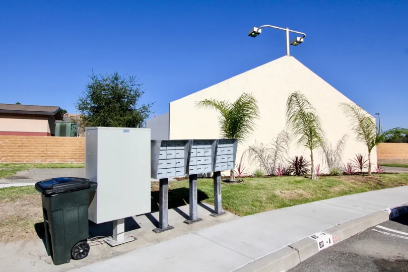 Metal mailboxes next to a trash can in Oceanside CA at Riverview Townhomes