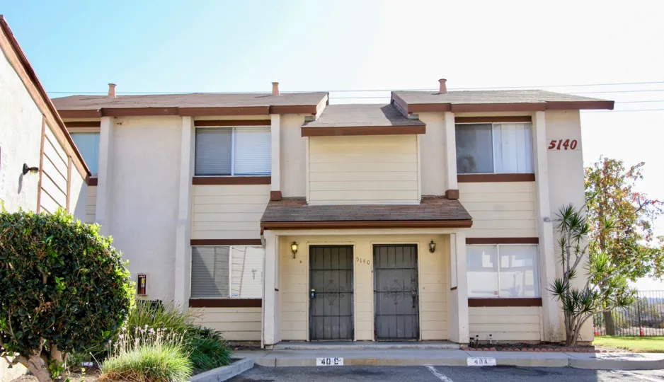 Two story housing with black iron doors inside the Riverview Townhomes in Oceanside CA