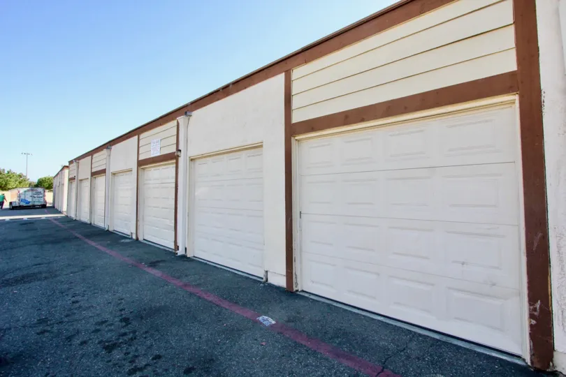 Brown and white garages lined up next to a street at Riverview Townhomes in Oceanside CA