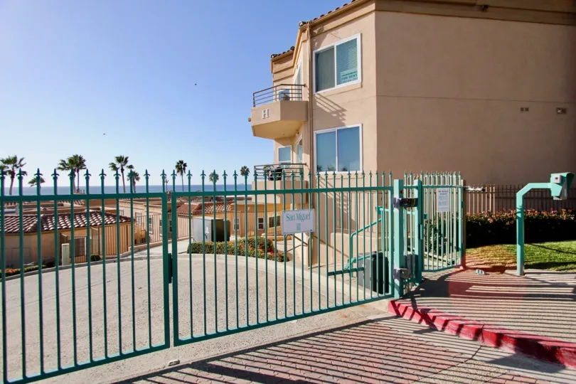 Light blue security fence across a driveway inside San Miguel III at Oceanside CA