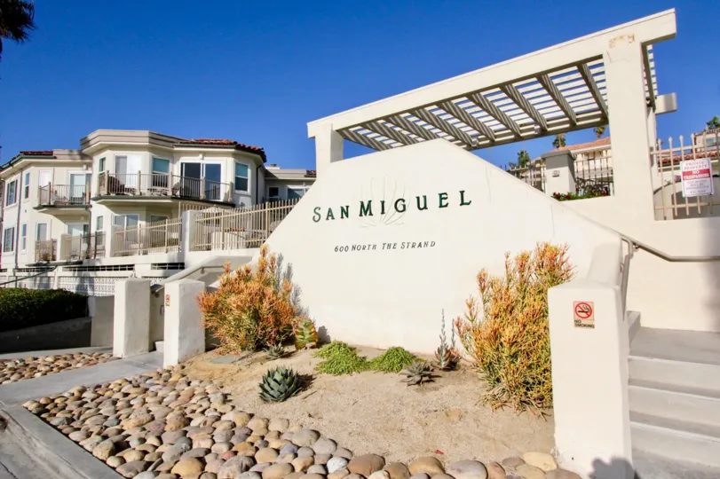 Large white sign with black writing in front of San Miguel in Oceanside CA