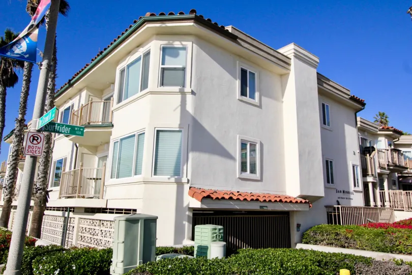 Three story white condos with parking underneath inside San Miguel in Oceanside CA