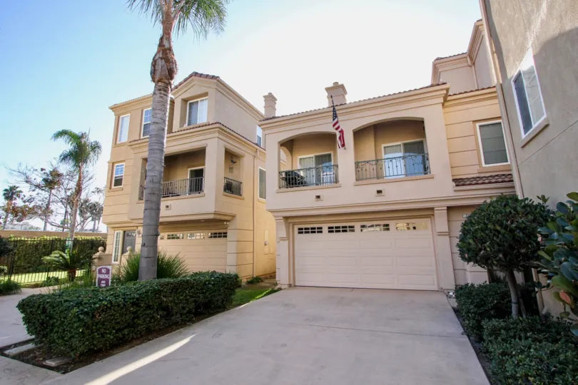 American flag flying from a three story town home inside the Sea Breeze Beach Cottages in Oceanside CA