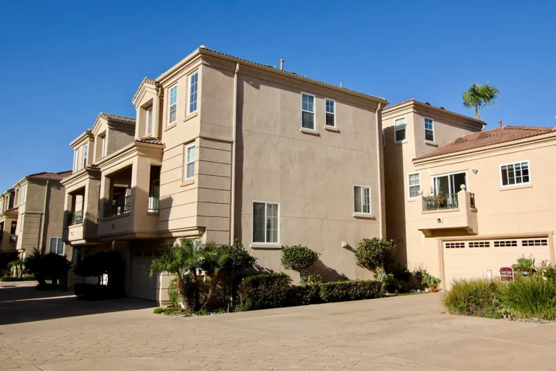 Large beige stone walls with several windows and great sunny view at Sea Breeze Beach Cottages.