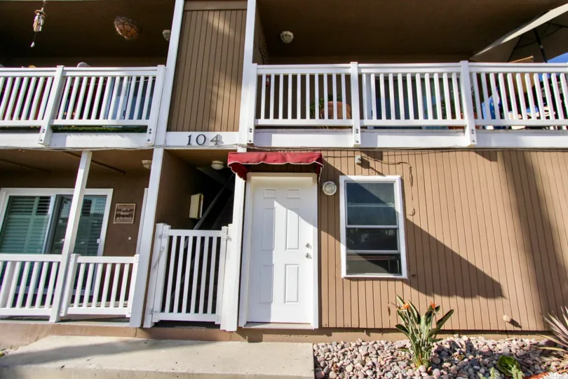 Front door with a red overhang in front of Sea Spray Villas ll in Oceanside, California