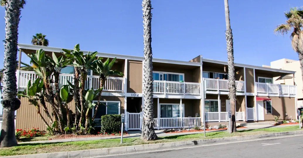 This apartment building is accented with lovely palm trees and other South-Western flora