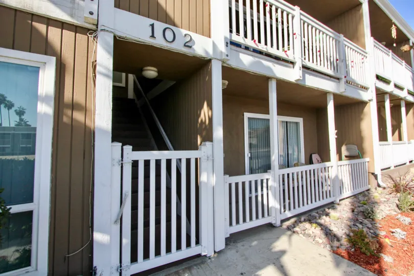 White railing on a brown wooden building at Sea Spray Villas II in Oceanside CA