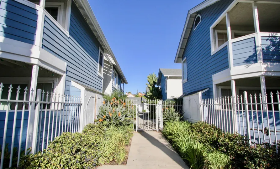 A gray sidewalk leading up to the entrance of Sea Village in Oceanside CA