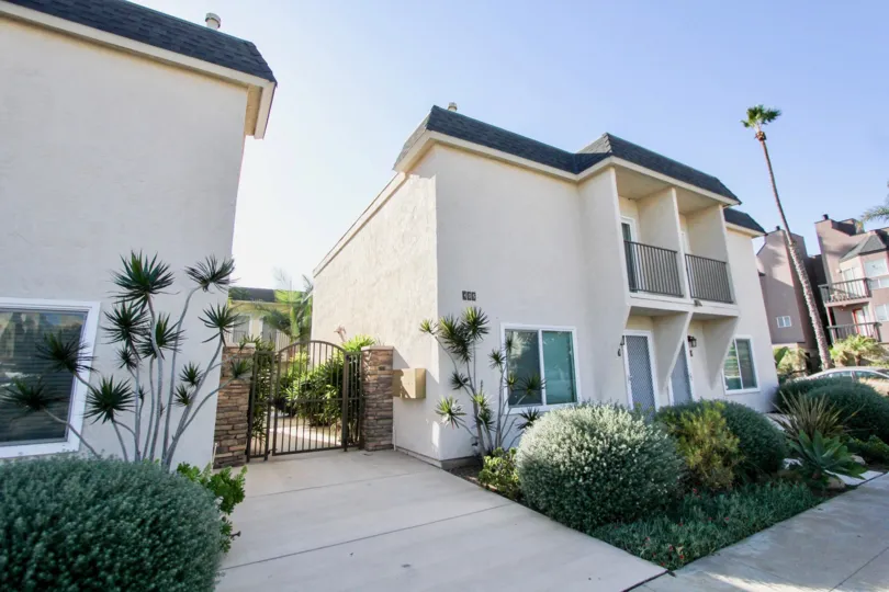 Two story house with gated back yard and patio with railings in Six Palms, in the city of Oceanside, California.