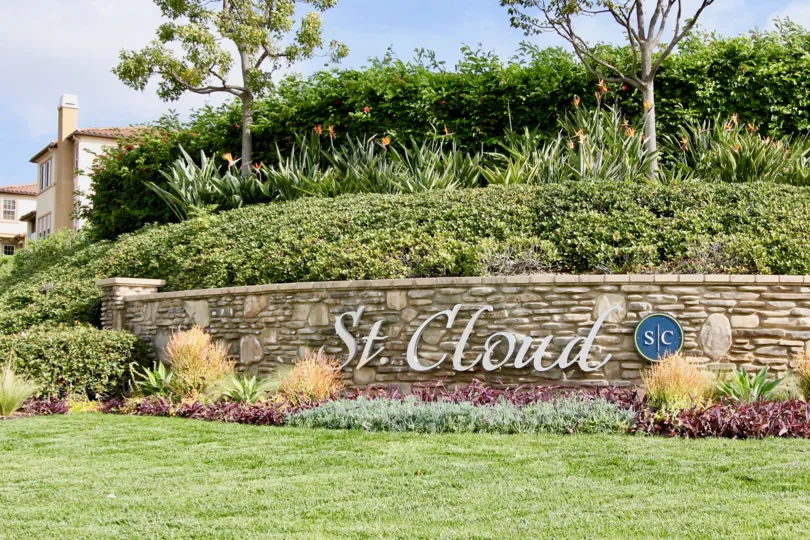 A sunny day in the area of St Cloud at Ocean Ranch, welcome sign, trees, flowers, grass